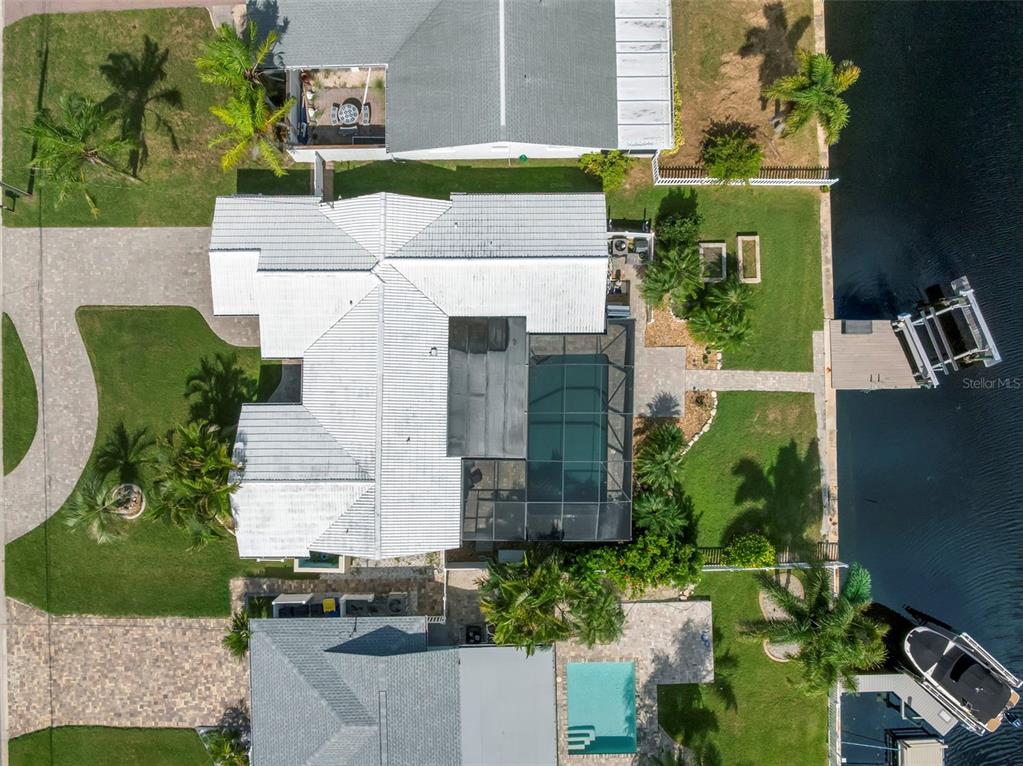 an aerial view of a house with a yard