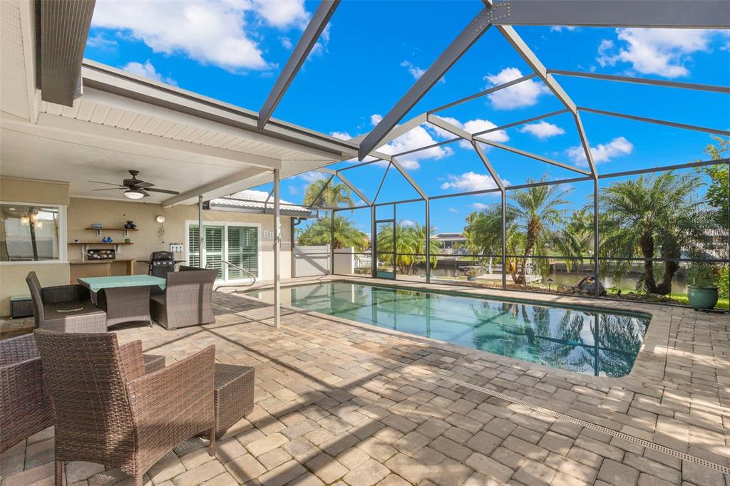 4003 Headsail Drive New Port Richey, FL 34652 - Photo 17 of 50 a view of a patio with a table and chairs under an umbrella