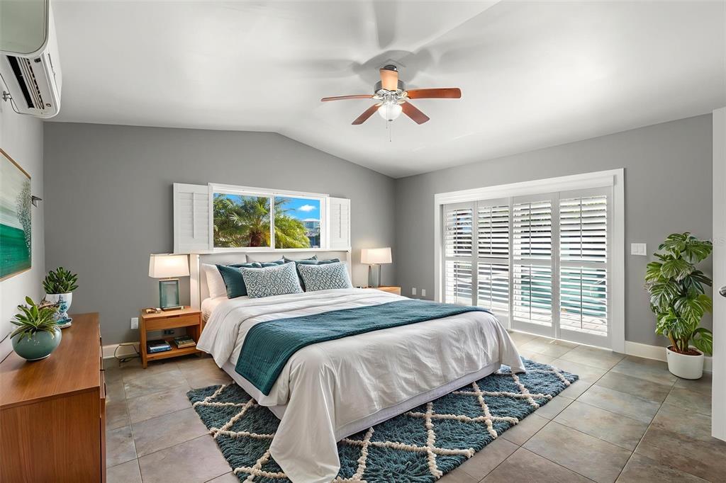 4003 Headsail Drive New Port Richey, FL 34652 - Photo 29 of 50 a bedroom with a large bed and a chandelier