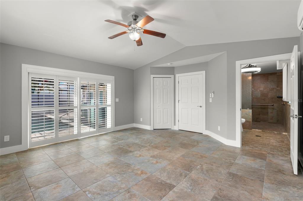 4003 Headsail Drive New Port Richey, FL 34652 - Photo 31 of 50 an empty room with chandelier fan and windows