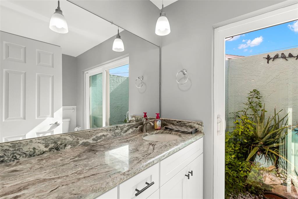 4003 Headsail Drive New Port Richey, FL 34652 - Photo 38 of 50 a bathroom with a granite countertop sink and a mirror
