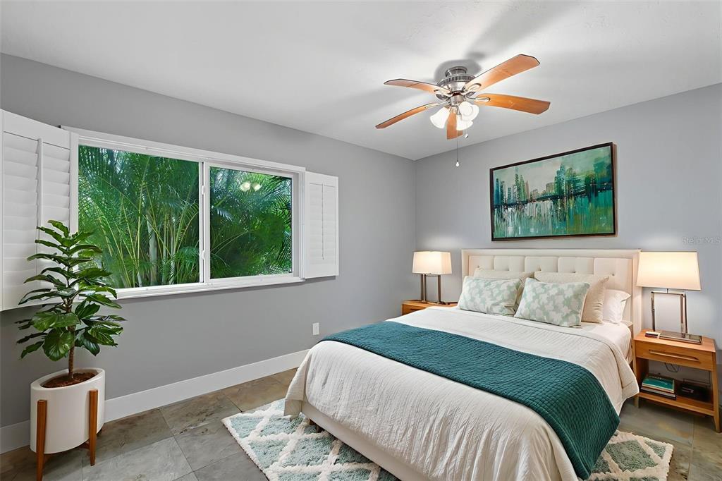 4003 Headsail Drive New Port Richey, FL 34652 - Photo 40 of 50 a bedroom with a large bed and a potted plant
