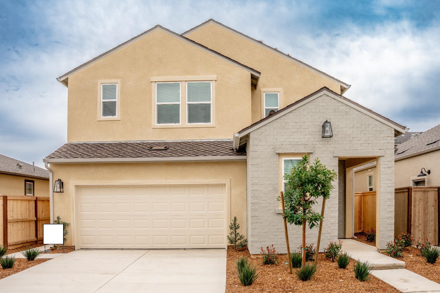 694 Thomas Way Madera, CA 93636 - Photo 2 of 27 a front view of a house with a outdoor space