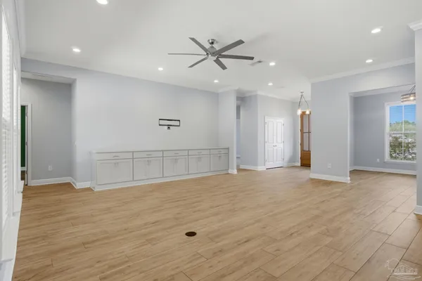 an empty room with wooden floor and a window