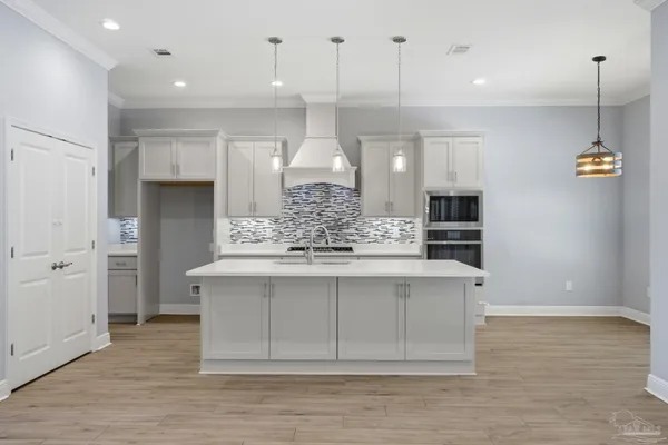 a large kitchen with stainless steel appliances kitchen island granite countertop a stove a sink and a refrigerator