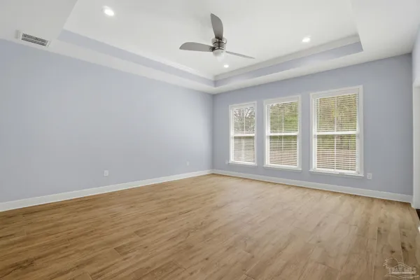 a view of a room with wooden floor and entryway