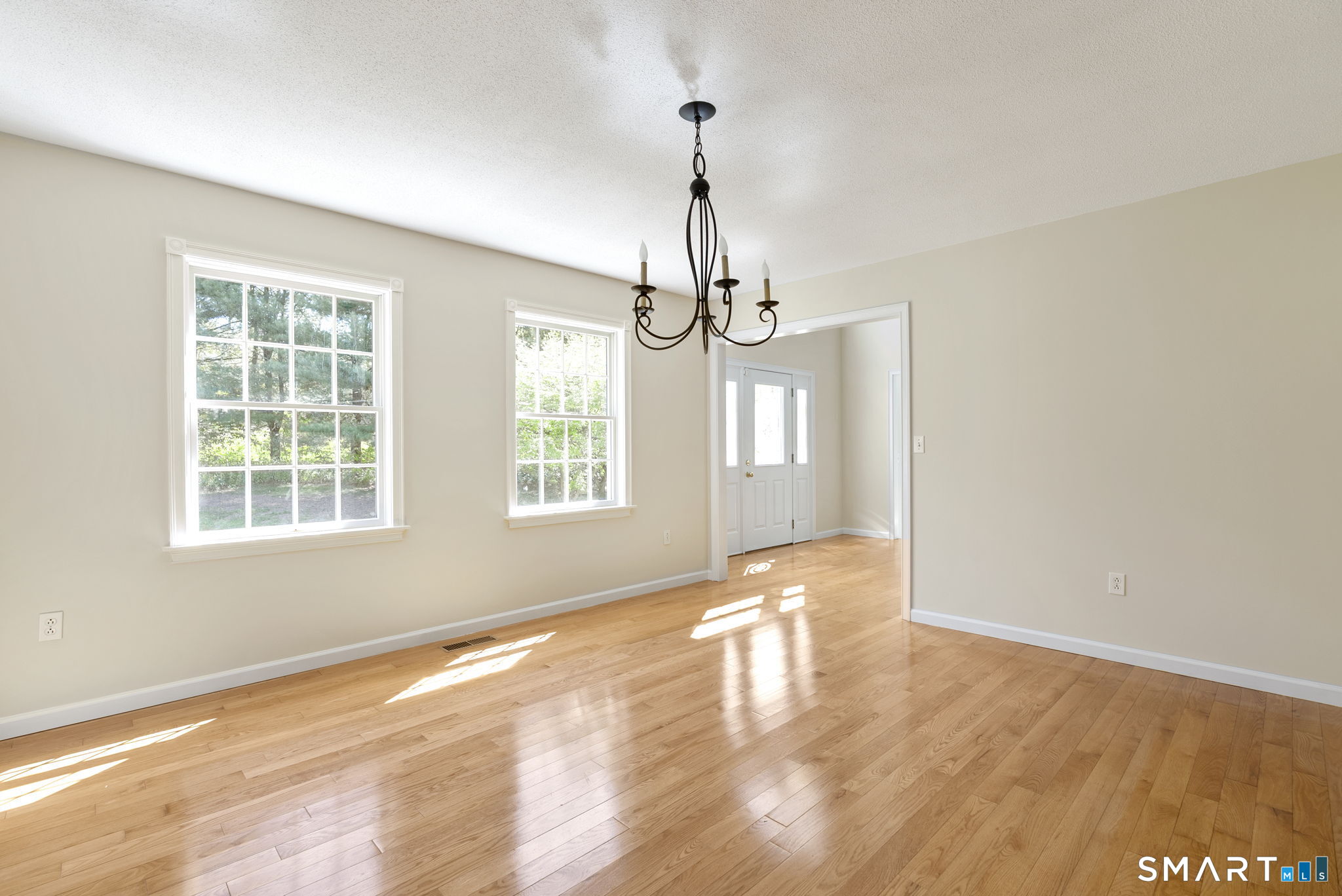 555 Waterville Road Avon, CT 06001 - Photo 13 of 40 a view of an empty room with wooden floor and a window