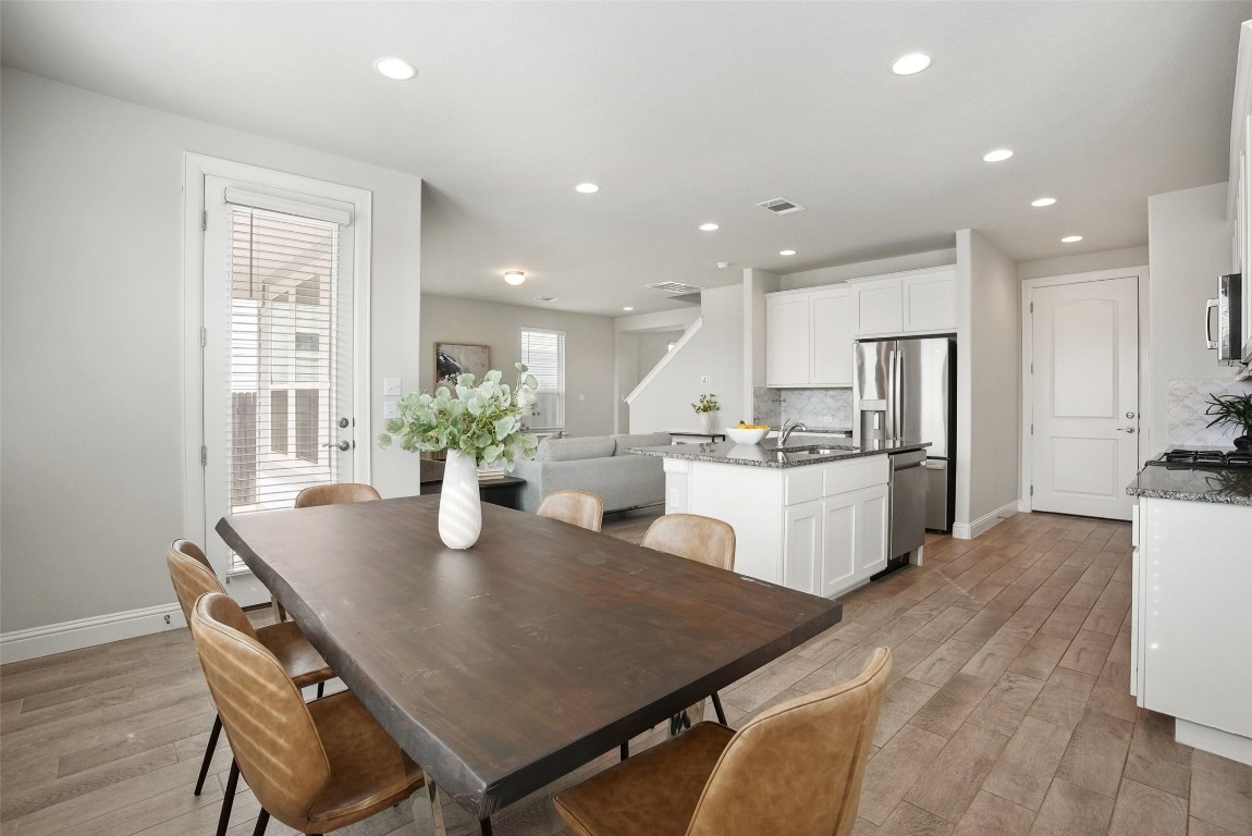 113 Stone Cyn Drive Georgetown, TX 78628 - Photo 16 of 35 a kitchen with kitchen island a stove a table and chairs