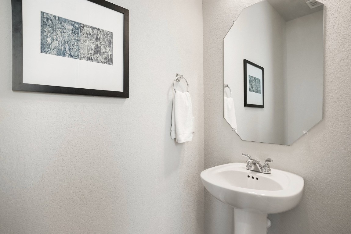 113 Stone Cyn Drive Georgetown, TX 78628 - Photo 27 of 35 a bathroom with a sink and a mirror