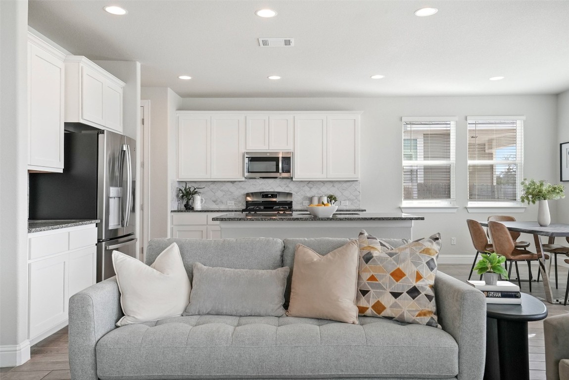 113 Stone Cyn Drive Georgetown, TX 78628 - Photo 5 of 35 a living room with furniture a flat screen tv and a refrigerator