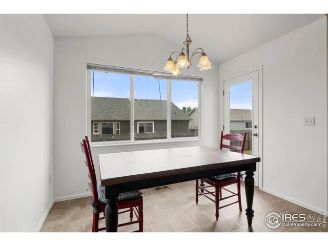 a view of a dining room with furniture and chandelier