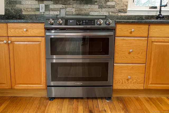 a stove top oven sitting inside of a kitchen