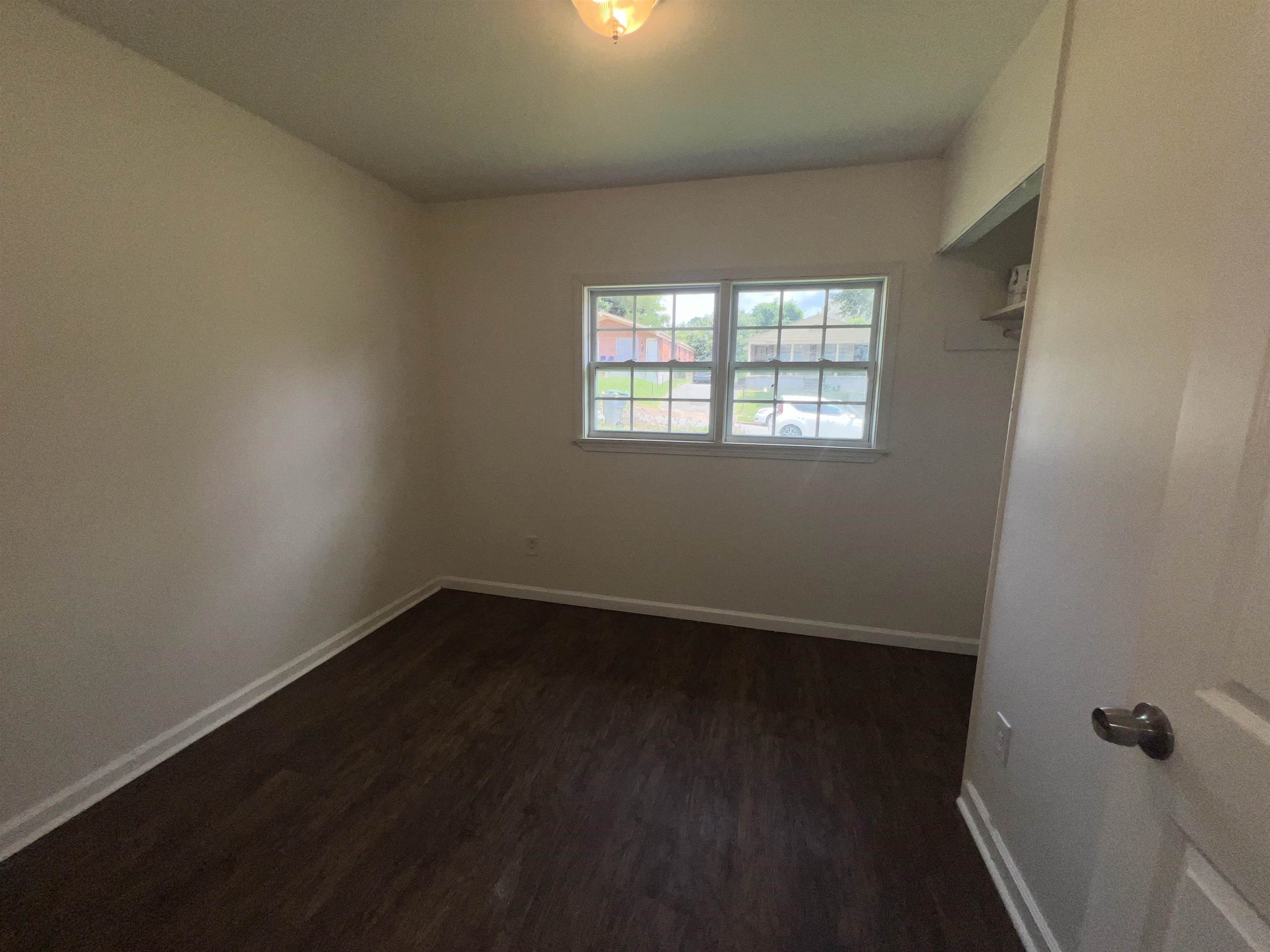 2235 Charjean Road Memphis, TN 38114 - Photo 12 of 15 Unfurnished room with baseboards and dark wood-style flooring