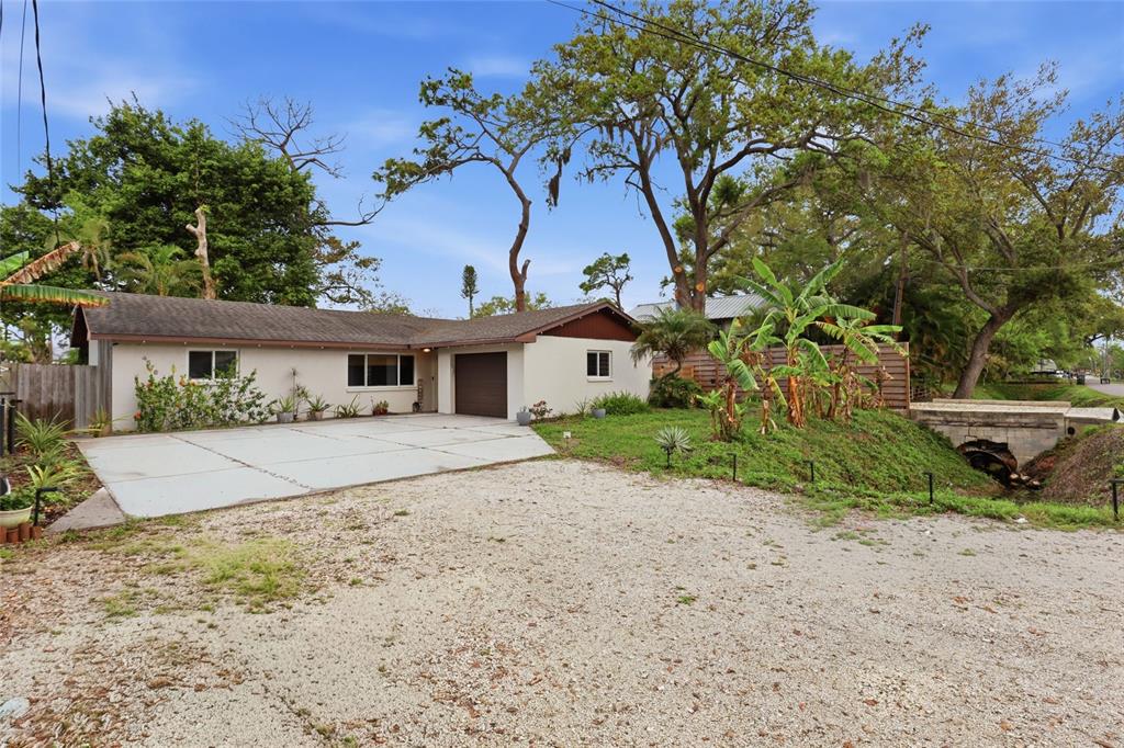 4576 Bliss Road Sarasota, FL 34233 - Photo 2 of 40 a front view of a house with a garden