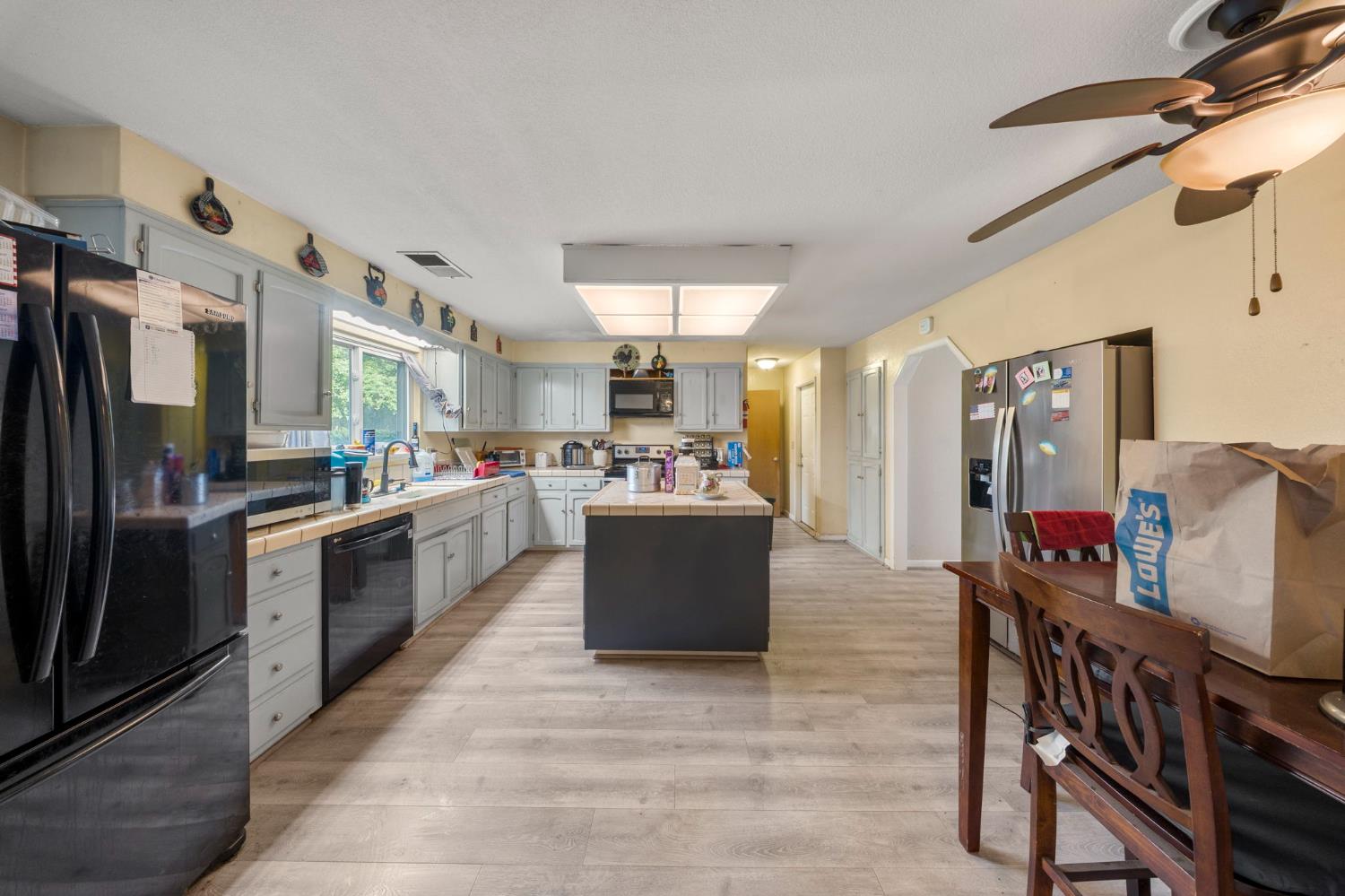 2779 Story Avenue Merced, CA 95340 - Photo 9 of 27 a large kitchen with stainless steel appliances lots of counter space and windows