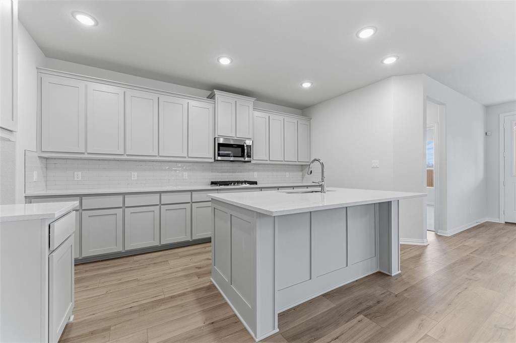 2012 Velora Drive Haslet, TX 76052 - Photo 11 of 33 a kitchen with kitchen island sink stove and cabinets