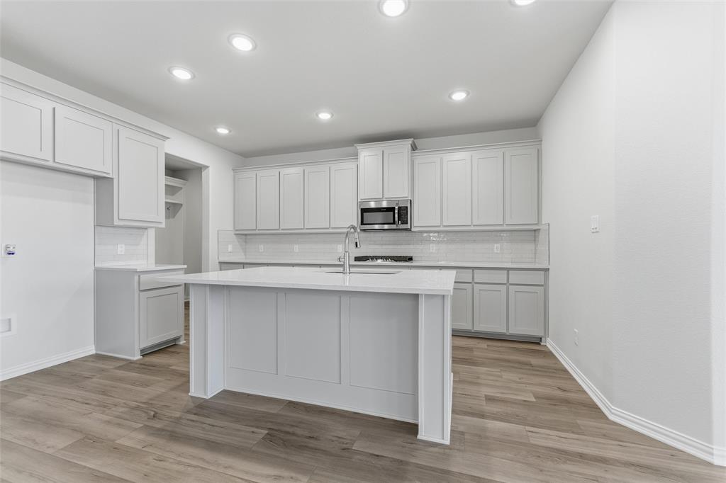 2012 Velora Drive Haslet, TX 76052 - Photo 13 of 33 a kitchen with white cabinets stainless steel appliances and a sink