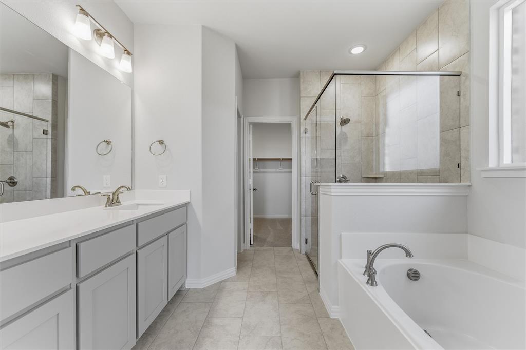 2012 Velora Drive Haslet, TX 76052 - Photo 16 of 33 a bathroom with a tub sink and mirror