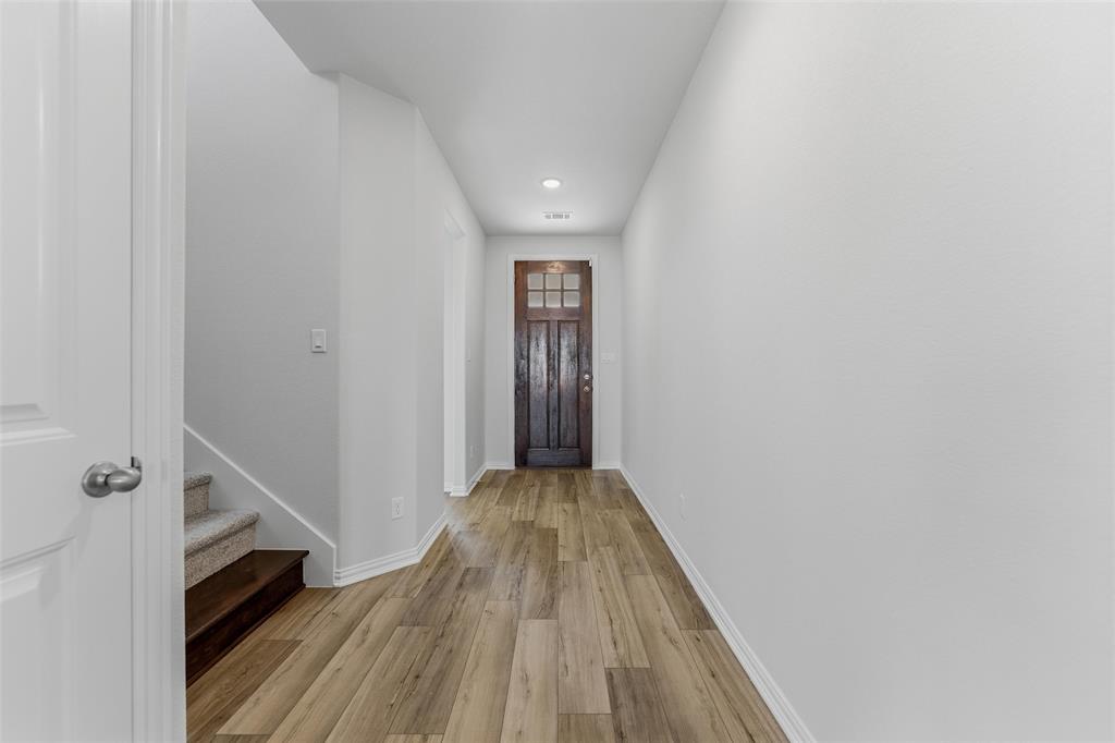 2012 Velora Drive Haslet, TX 76052 - Photo 9 of 33 a view of a hallway with wooden floor and staircase