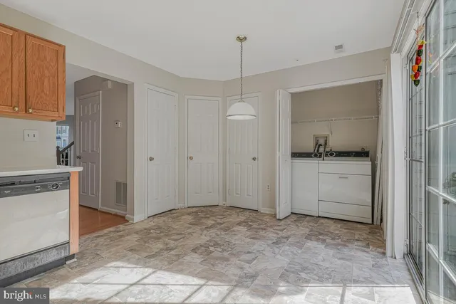 a view of a kitchen with a sink and dishwasher oven with white doors