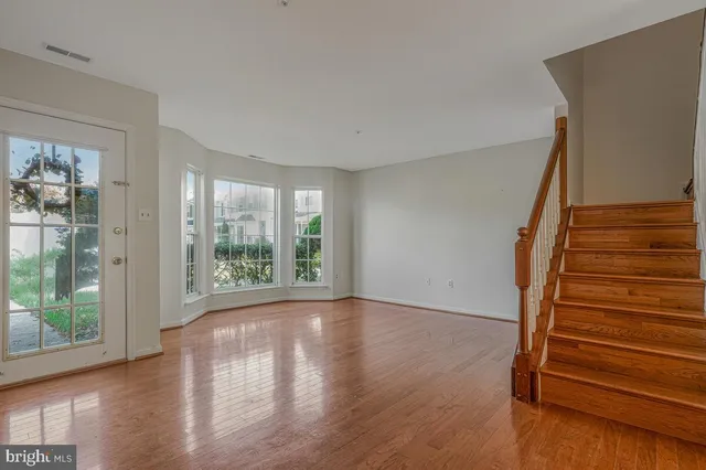 a view of entryway with wooden floor and stairs