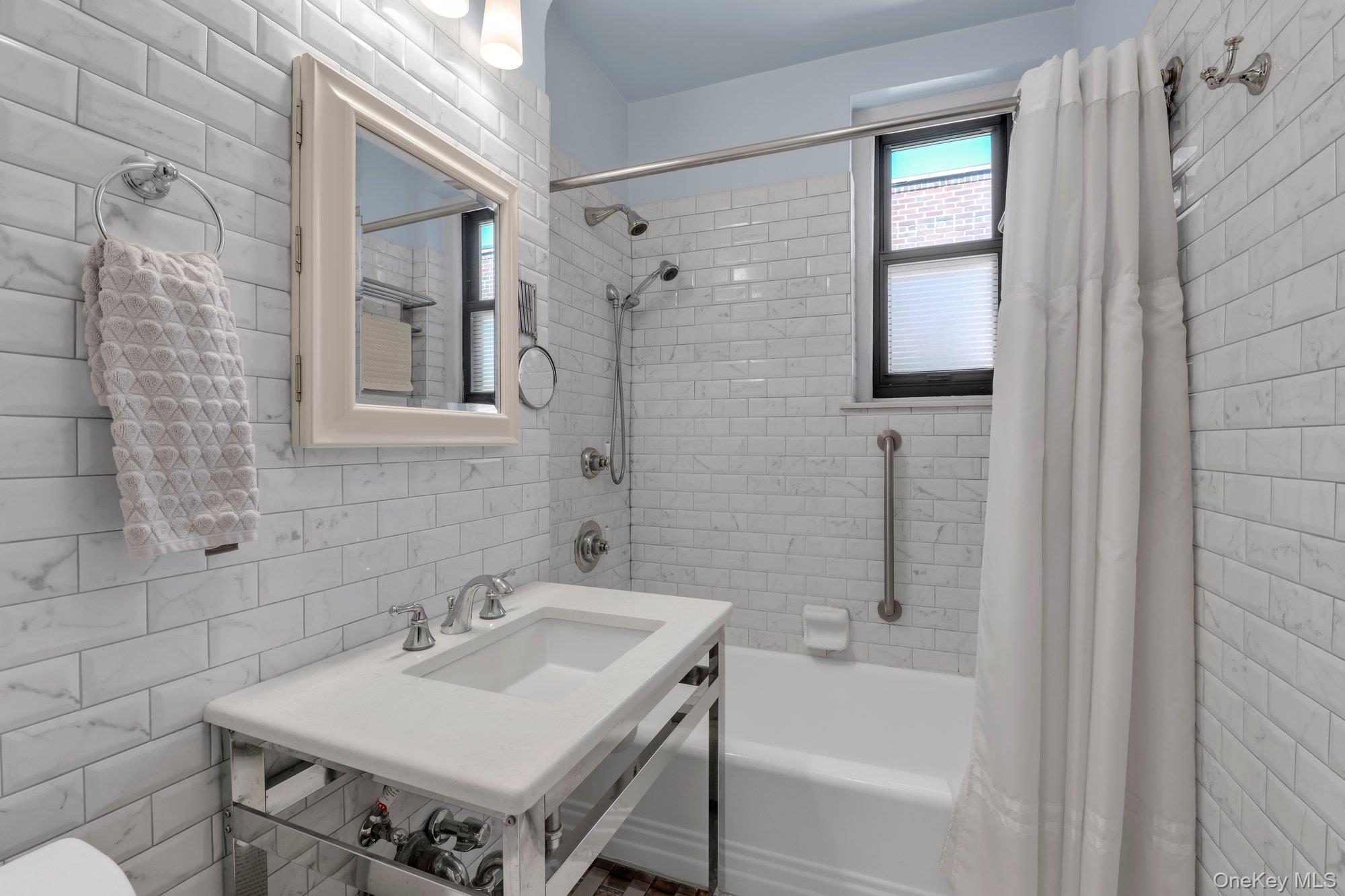 84-51 Beverly Road, Unit 6A Queens, NY 11415 - Photo 9 of 14 a bathroom with a sink and a bathtub