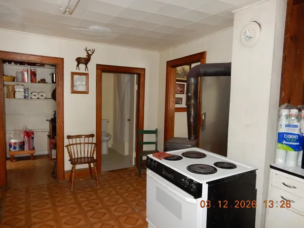 a kitchen that has a stove and a table in it