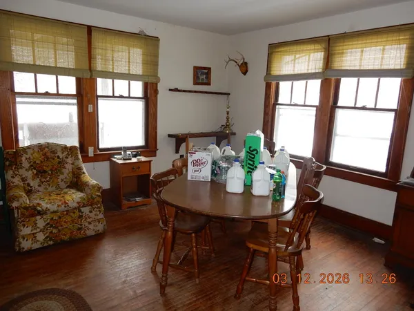 a view of a dining room with furniture and a window