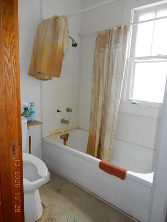 a bathroom with a toilet and a bathtub