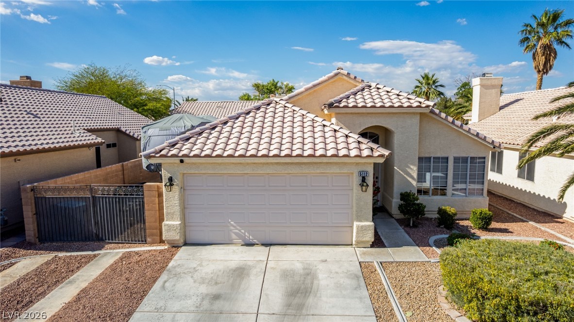 5112 West Camino Del Rancho Las Vegas, NV 89130 - Photo 33 of 44 This charming home offers a convenient attached garage and desert-friendly landscaping.