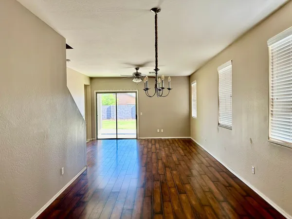a view of a room with wooden floor staircase and a window