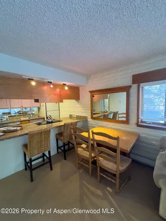 a room with pool table and chairs