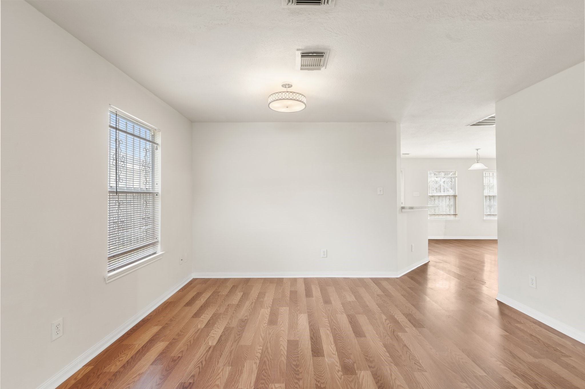 3111 Holly Ranch Drive Katy, TX 77494 - Photo 4 of 28 an empty room with wooden floor and windows