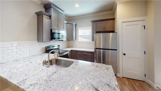 a kitchen with a refrigerator sink and cabinets