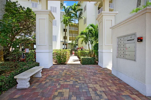 a view of a hallway with wooden floor and a potted plant