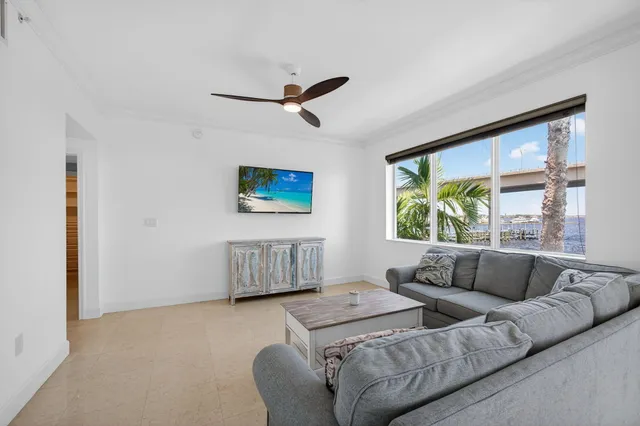 a view of a dining room and kitchen with a table chairs