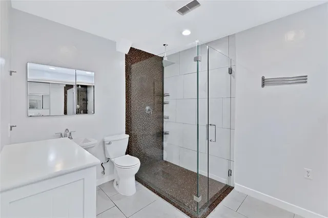 a bathroom with a toilet sink and shower