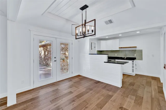a view of kitchen with refrigerator microwave and stove top oven