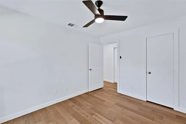 a view of a room with wooden floor