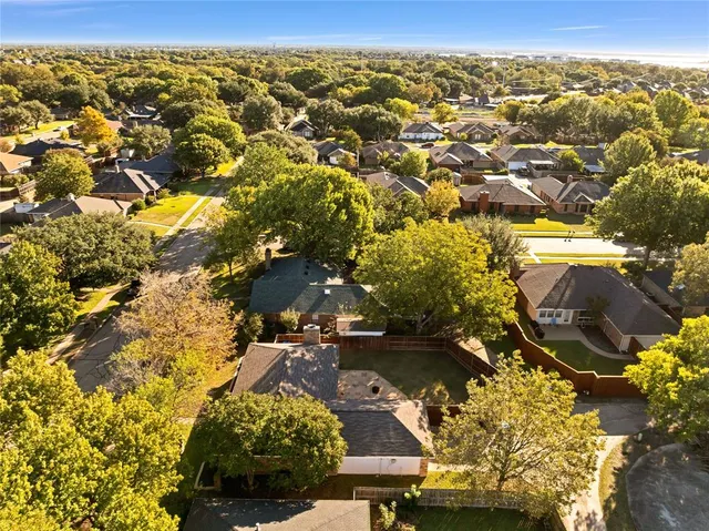 an aerial view of residential houses with outdoor space