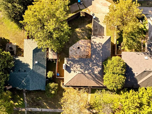 an aerial view of a house with yard