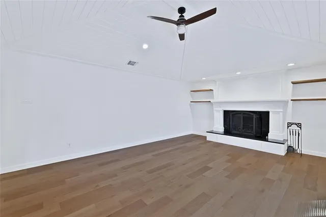 an empty room with a empty space and a ceiling fan