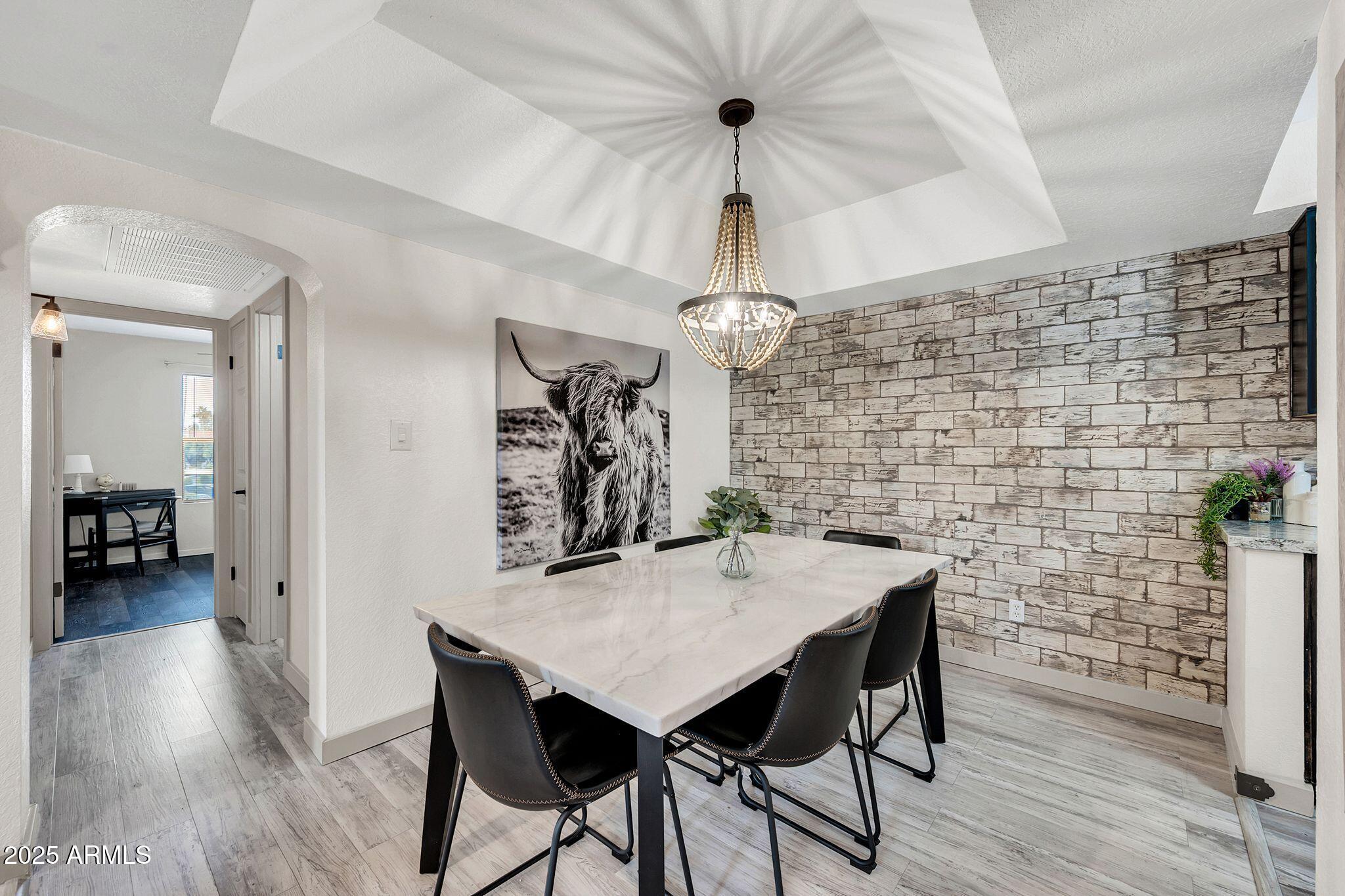 8787 East Mountain View Road, Unit 2100 Scottsdale, AZ 85258 - Photo 12 of 47 a view of a dining room with furniture and wooden floor