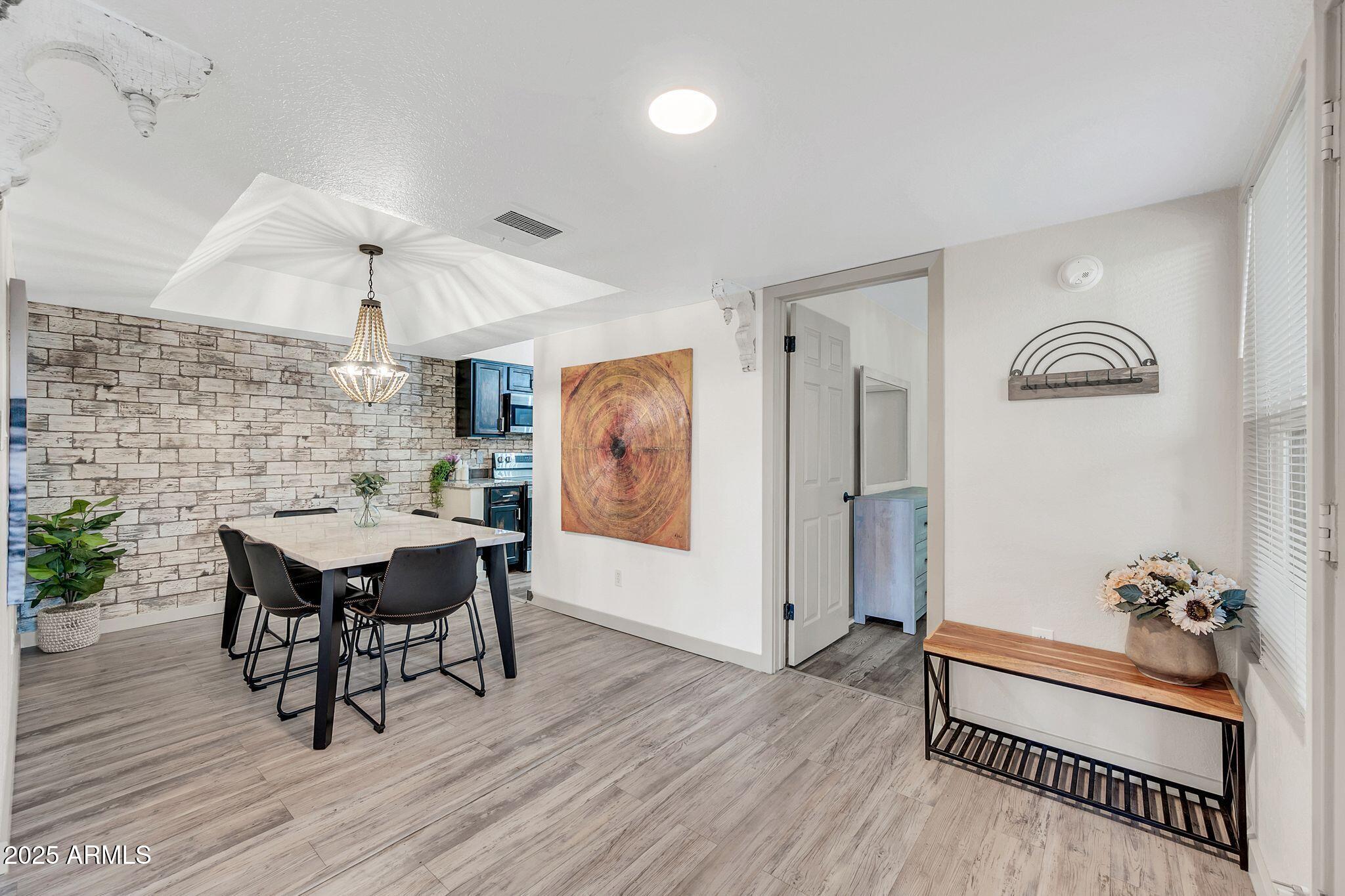 8787 East Mountain View Road, Unit 2100 Scottsdale, AZ 85258 - Photo 13 of 47 a view of a dining room with furniture and wooden floor