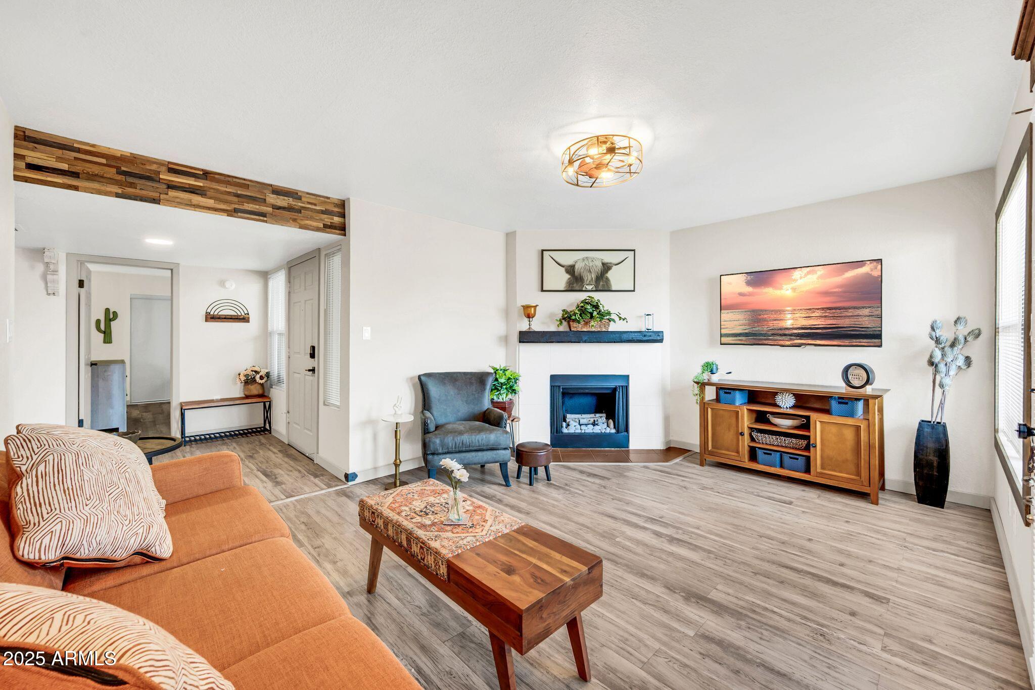 8787 East Mountain View Road, Unit 2100 Scottsdale, AZ 85258 - Photo 16 of 47 a living room with furniture a flat screen tv and a fireplace