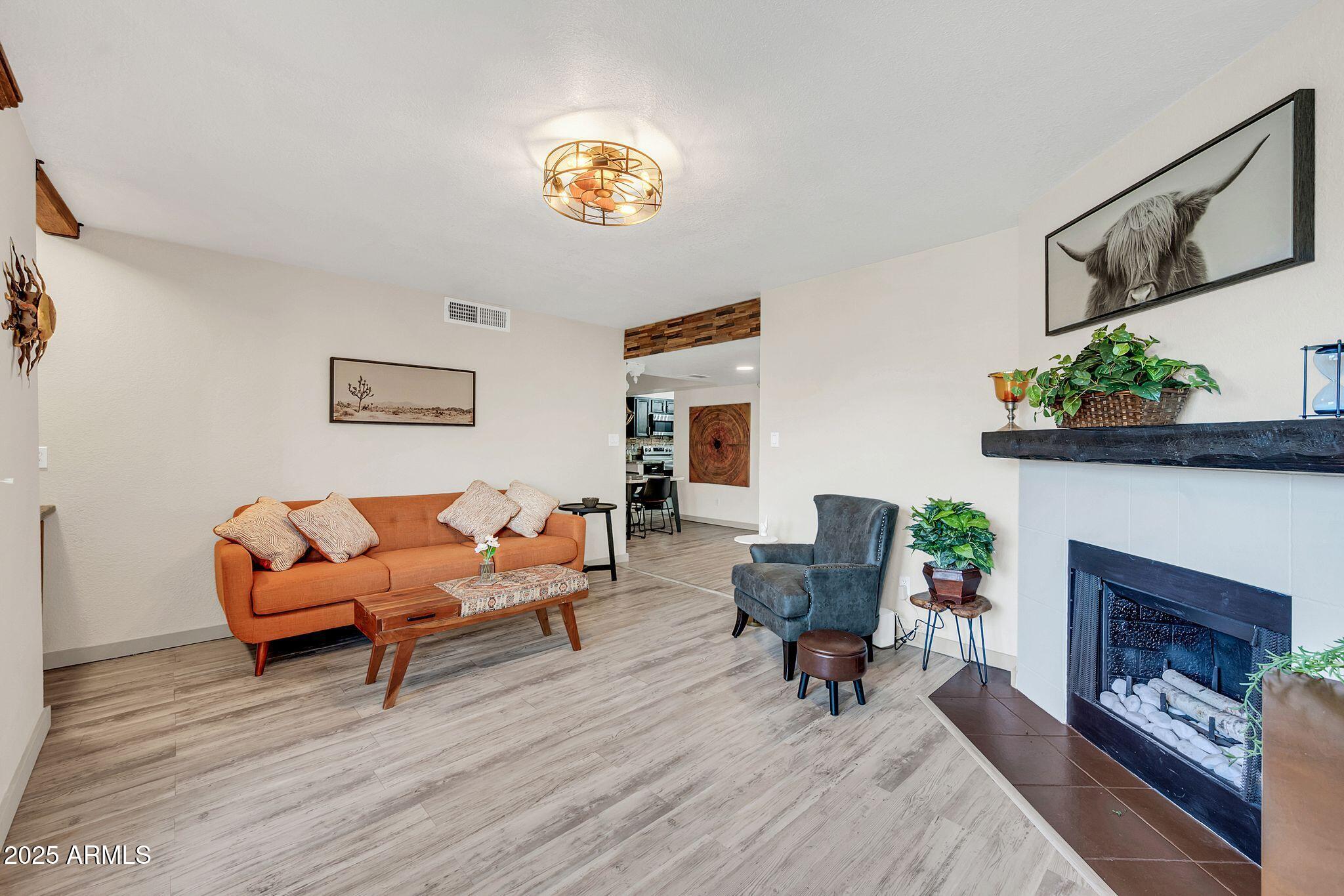 8787 East Mountain View Road, Unit 2100 Scottsdale, AZ 85258 - Photo 15 of 48 a living room with furniture and a fireplace