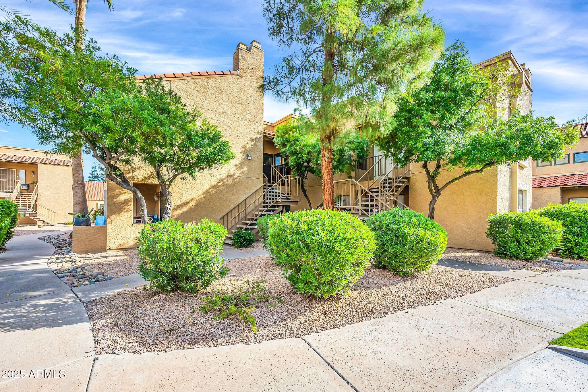 8787 East Mountain View Road, Unit 2100 Scottsdale, AZ 85258 - Photo 2 of 47 a front view of a house with garden