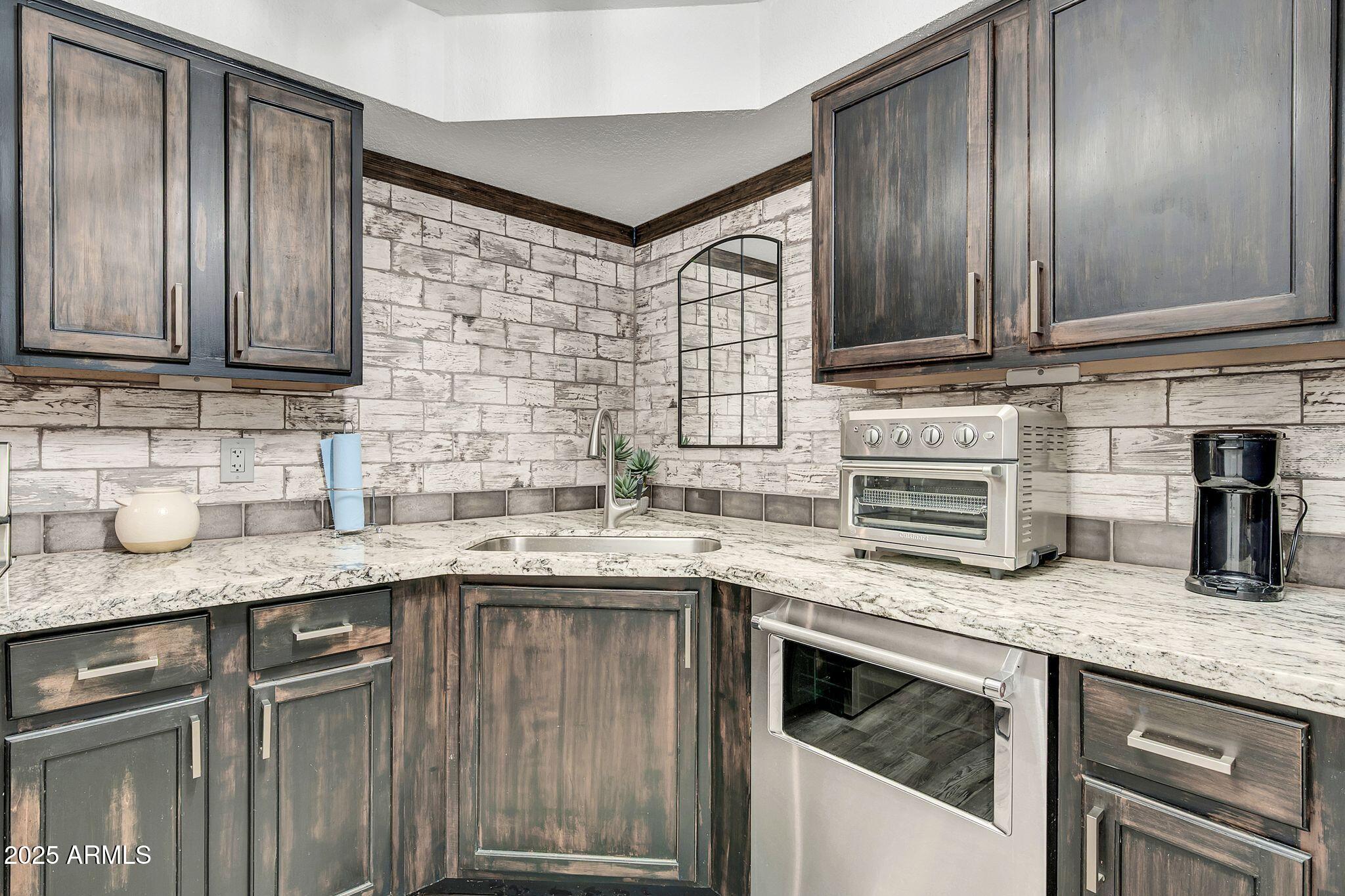 8787 East Mountain View Road, Unit 2100 Scottsdale, AZ 85258 - Photo 24 of 47 a kitchen with granite countertop stainless steel appliances and sink