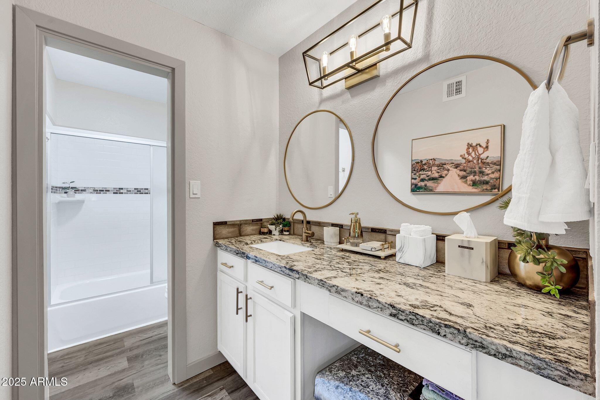 8787 East Mountain View Road, Unit 2100 Scottsdale, AZ 85258 - Photo 27 of 48 a bathroom with a granite countertop double vanity sink and a mirror