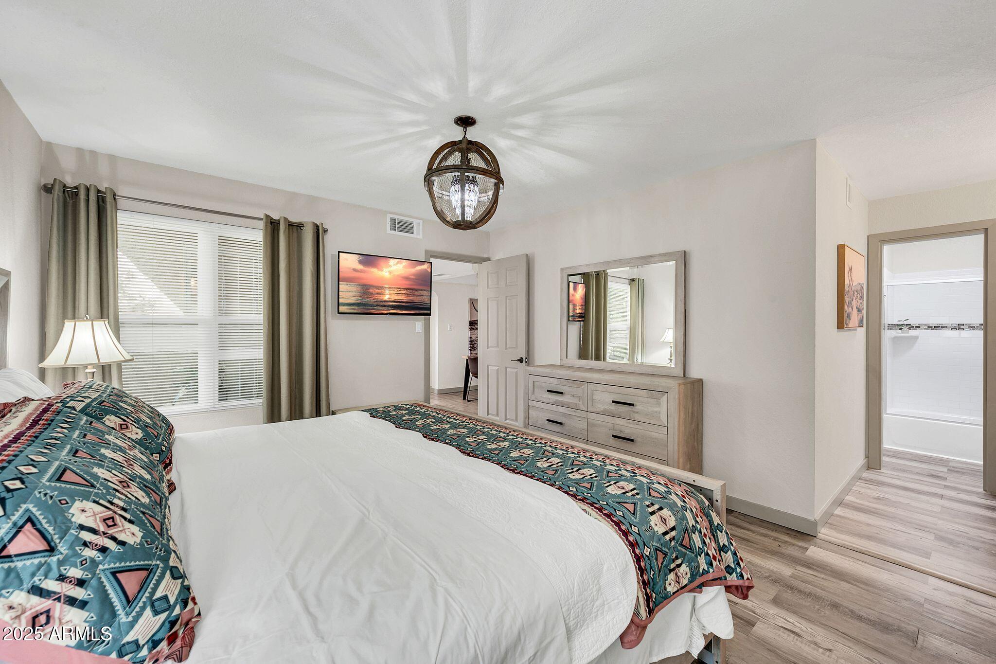 8787 East Mountain View Road, Unit 2100 Scottsdale, AZ 85258 - Photo 29 of 48 a bedroom with a bed and a window